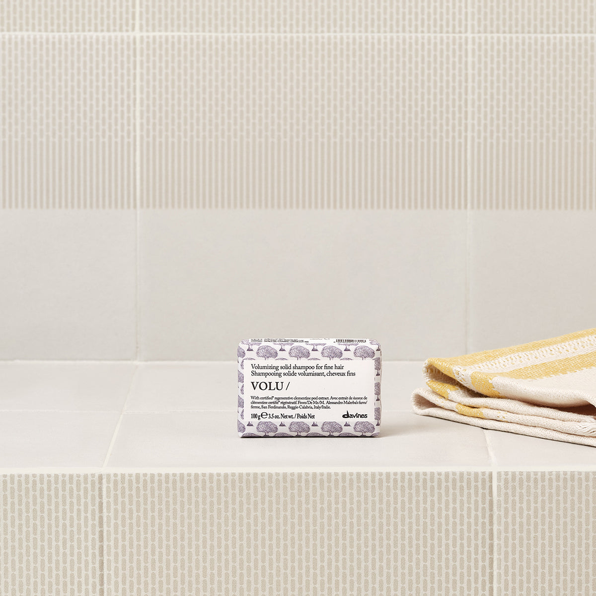 Lifestyle photo of Davines Volu Solid Shampoo bar for fine hair