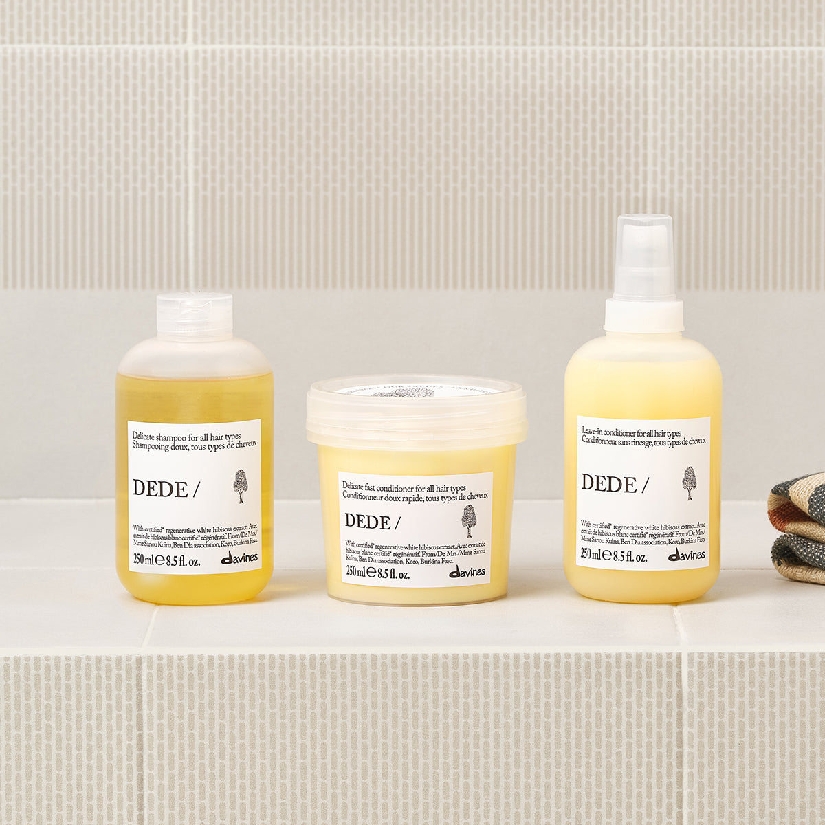 Davines DEDE Leave-In Conditioner shown in a styled bathroom setting